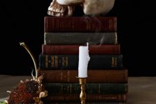 simple and elegant vintage Halloween decor with a stack of vintage books and a skull on top is amazing for your party