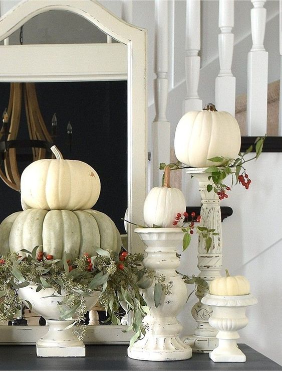 white and green pumpkins, greenery and berries, white shabby chic candleholders and stands