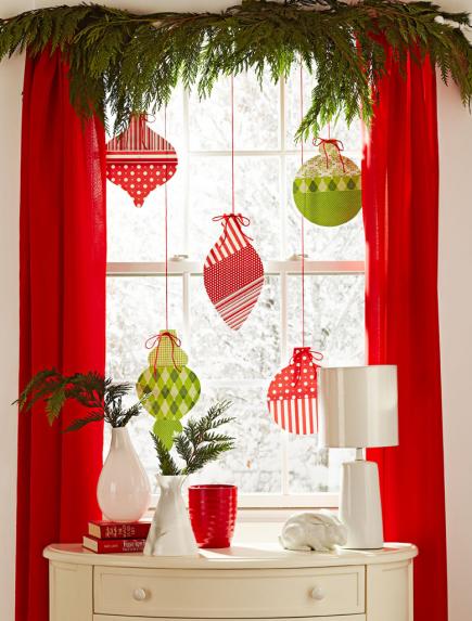 Make some oversized Christmas ornaments from craft paper to make your window's decor visible from outside.
