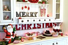 Santas, red letters, ornaments, evergreens, stockings, lights and candles for Christmas decor