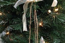 a Christmas ornament of silver glitter bells, white ribbon bows is an easy decoration that you can DIY
