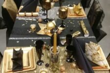 a fun black and gold tablescape with stars, stripes and candles is amazing for a New Year’s Eve