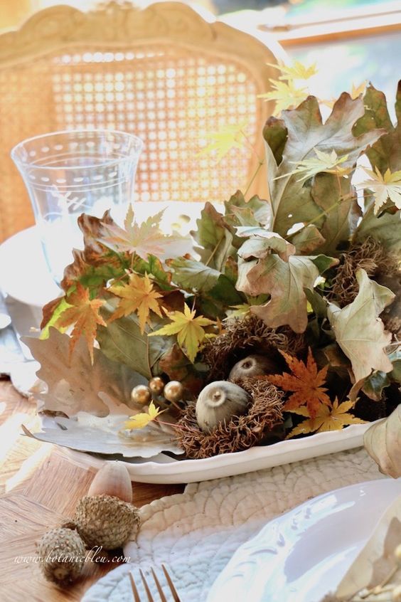 A lovely all natural Thanksgiving centerpiece of fall leaves, acorns, fruits and other stuff can be made last minute