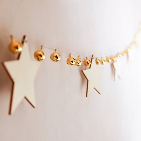 a lovely garland of plywood stars and gold bells is ideal for Christmas, add a shiny touch with them