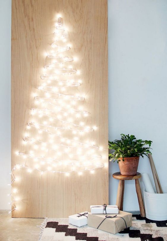 a minimalist Christmas sign with lights that form a Christmas tree is a stylish idea that can be easily DIYed