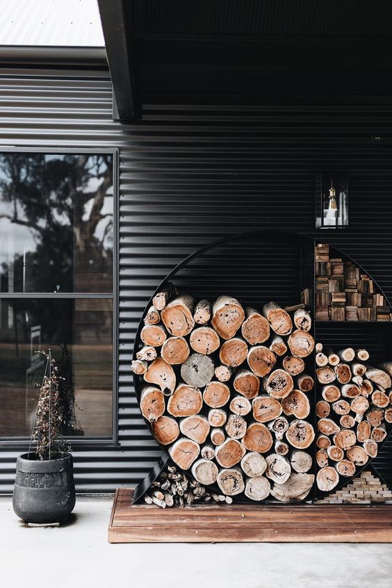 a minimalist firewood storage shaped as a circle is a great idea for both indoors and outdoors