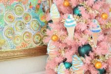 a pastel pink table Christmas tree with gold, teal and ice cream ornaments is a fun and pretty idea for a vintage space