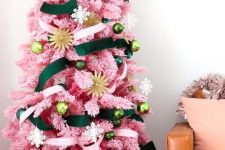 a pink Christmas tree with emerald and neutral ribbons and ornaments in various shades of green plus gold touches