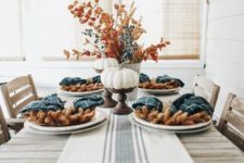a simple and rustic tablescape done with teal plaid napkins and a striped runner that contrast the earthy tones here