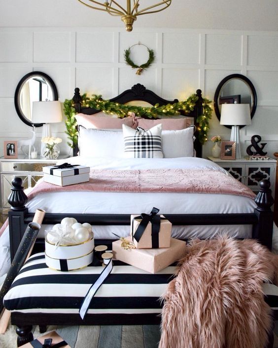 a super elegant Christmas bedroom with pearly ornaments, a greenery and light garland, a mini wreath with bells
