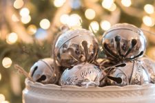 a vintage white stand with vintage silver bells is a chic last-minute Christmas centerpiece or just decoration to rock