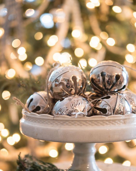 A vintage white stand with vintage silver bells is a chic last minute Christmas centerpiece or just decoration to rock