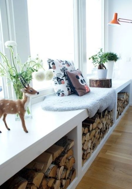 a windowsill bench with storage allows storing there some firewood for your fireplace and add coziness to the room