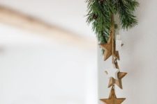an evergreen and wooden star posie attached to the corner is a stylish all-naturla idea to go for