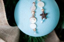 an oversized blue Christmas ornament with pearls, a starfish and beads is a lovely idea for a beach Christmas space