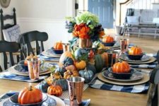 blue and white plaid placemats, blue and orange pumpkins, blue flwoers and striped napkins for Thanksgiving