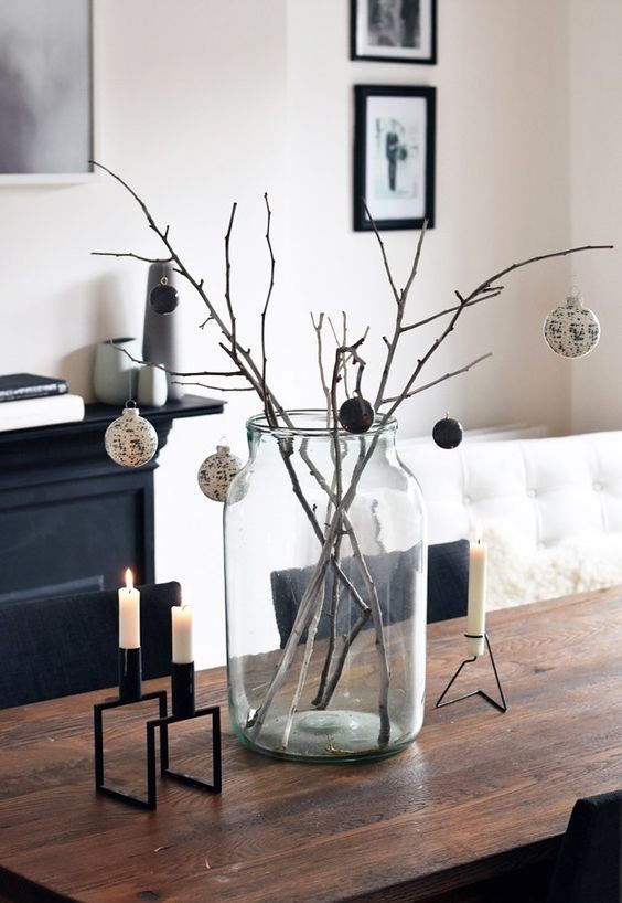 branches in a jar and black and white ornaments for a stylish arrangement, candles in black candleholders