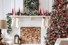 bright and bold Christmas living room decor with red mini trees, a greenery garland, a greenery and berry wreath, a Christmas tree with bold red ornaments and beads