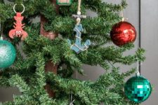 coastal Christmas tree decor with red, green and silver ornaments, anchor, crab and boat ones is amazing