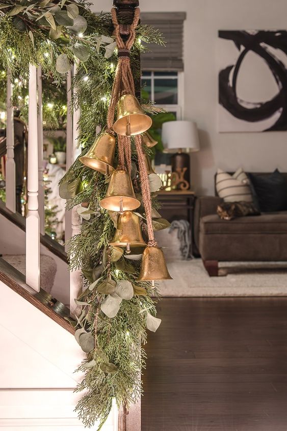 Decorate the railing with foliage, fir branches, lights and vintage bells to make your space look very holiday like