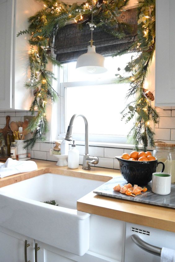 evergreens and greenery Christmas garland with pinecones and lights for decorating the kitchen