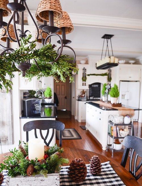 evergrens, pinecones and candles for a cozy farmhouse and rustic feel in the holiday kitchen