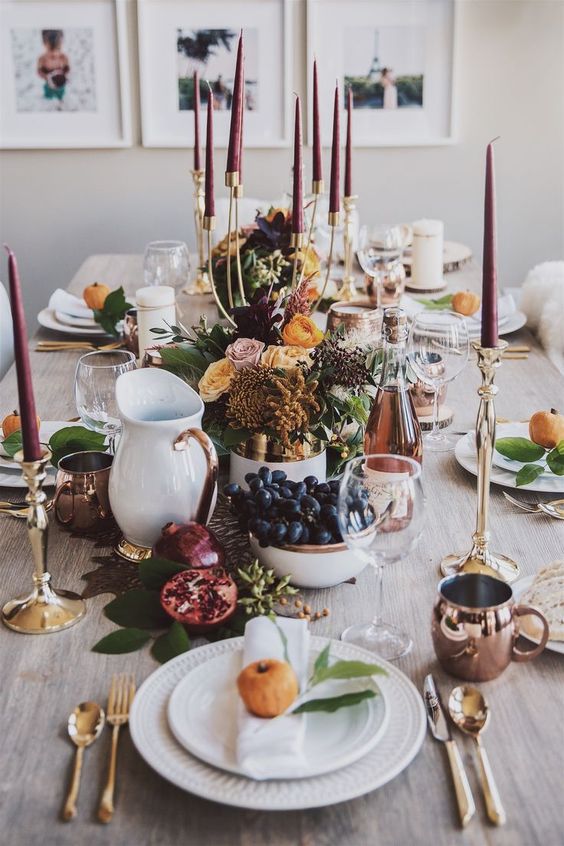 fruits, berries, leaves, bold blooms and burgundy candles for a modern natural Thanksgiving tablescape