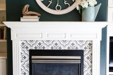 grey and white pattern mosaic tiles around the fireplace and on the floor plus a vintage white mantel create a chic and refined look