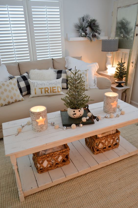 lovely holiday decor with star candleholders, white and silver bell garland, a couple of mini trees and a flocked Christmas wreath