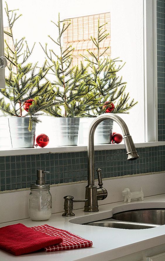 mini Christmas trees in buckets with red ornaments are all that you need for a holiday feel in the space
