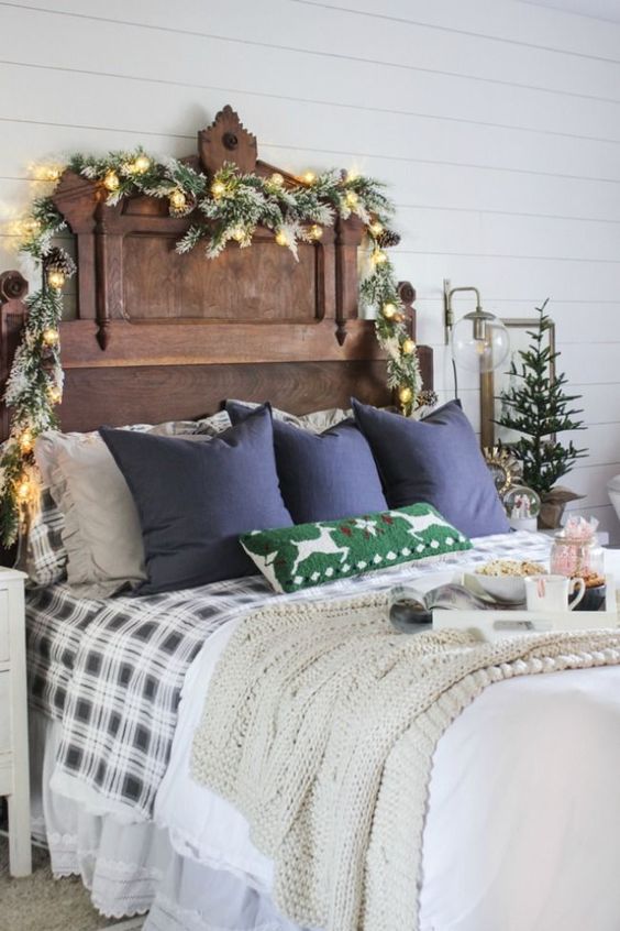 snowy evergreens, lights and pinecones, a mini Christmas tree, plaid bedding and a knit blanket for a festive feel