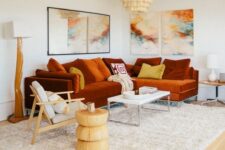 a bold living room with a rust-colored modern sectional and a bright gallery wall plus statement lamps