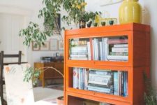 a bright orange bookcase with glass covered compartments is a great touch of color and a cute piece