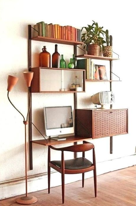 A chic mid century modern wall unit with closed compartments, open shelves and a small desk integrated