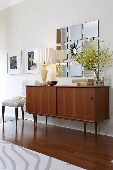 A classy rich stained mid century modern sideboard with two sliding doors on cone legs is a lovely idea for a modern space