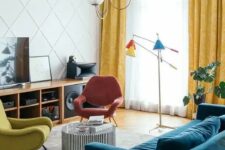 a colorful living room with a stained storage unit, a navy velvet sofa, a striped coffee table, colorful chairs, a bright floor lamp and a paneled wall