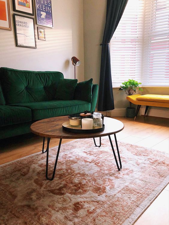 A cool mid century modern coffee table with a rich stained round tabletop and hairpin legs is pure elegance and timeless style for your living room