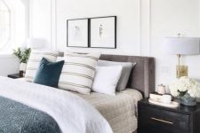 a grey upholstered bed and dark fabric upholstered nightstands for a welcoming and cool space