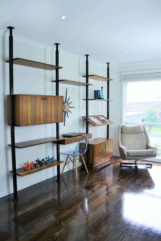 A large yet airy mid century modern unit with closed compartments, shelves and slanted shelves all placed asymmetrically