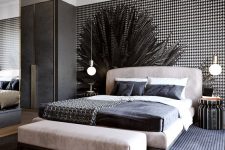 a light leather upholstered bed and a matching bench and striped nightstands for a bold touch