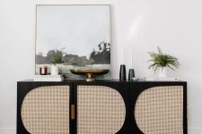 a lovely mid-century modern sideboard of an IKEA piece, in black and with cane doors is a very cool idea for a refined room