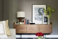 a mid-century modern stained sideboard with sleek doors with no handles and thin metal legs is a lovely idea to rock