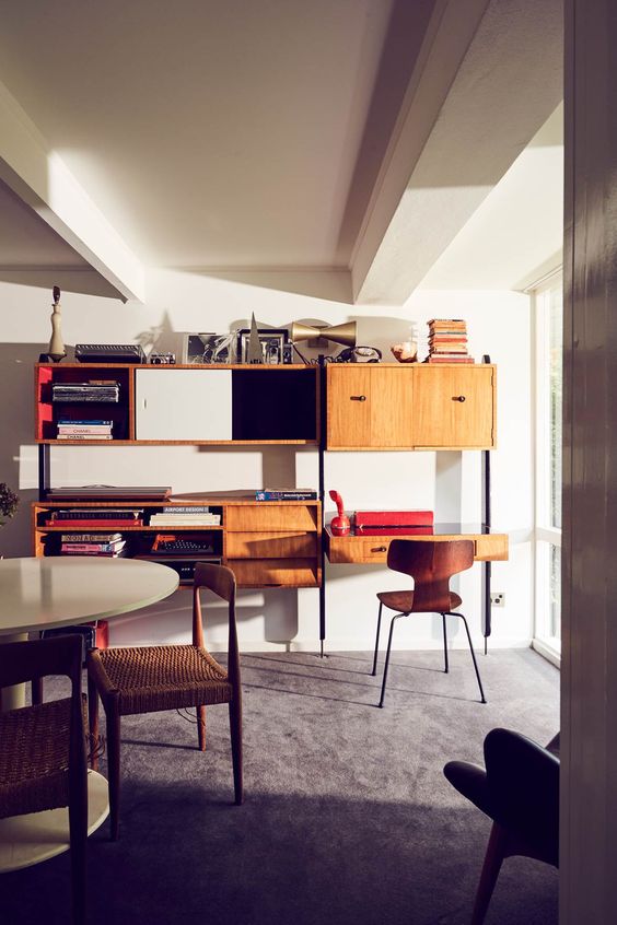 A mid century modern unit with drawers, closed and open storage unit with a desk in the lower part