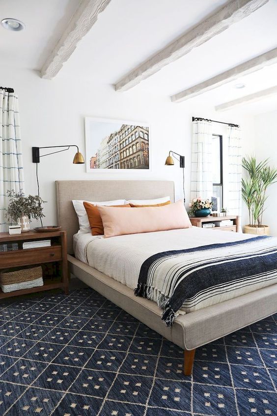 a neutral upholstered bed and rich stained nightstands will create a cozy base for a mid-century modern space