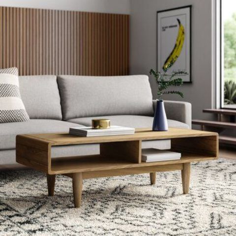 a pretty light-stained coffee table with two open storage compartments inside and tapered legs is a cool idea for a stylish living room