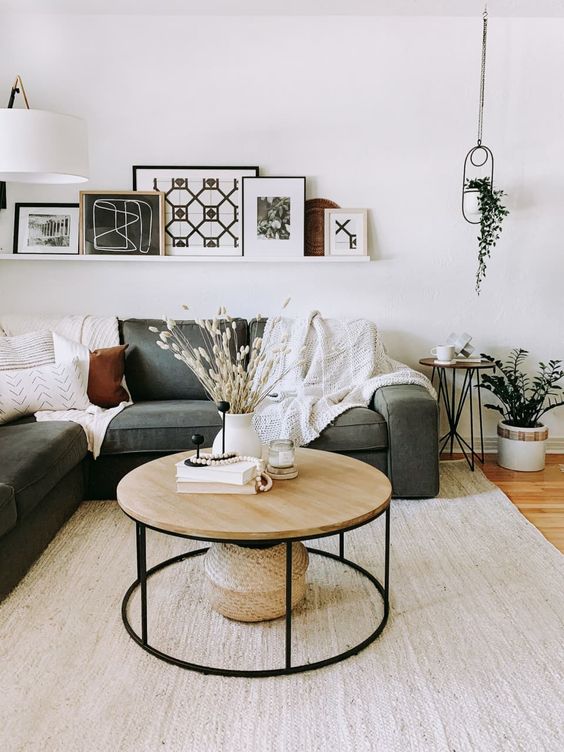 a pretty mid-century modern and Scandi table with a black metal round base and a light-stained wooden tabletop for a contrast