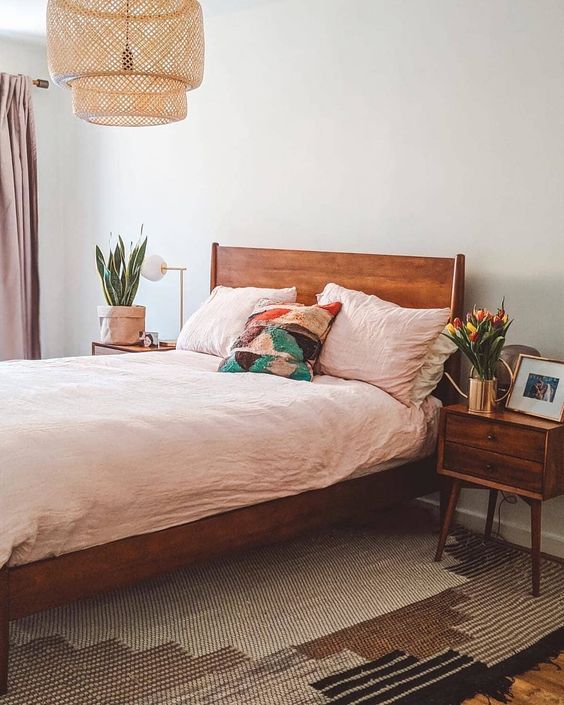 a rich stained mid-century modern bed and matching nightstands will make the space warming up and cozy