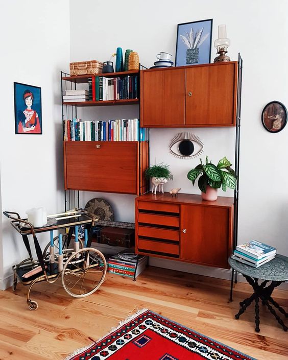 a rich stained teak wall unit with cabinets, drawers and some open shelves is a very comfy and practical unit