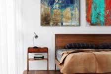 a rich-stained wooden bed and matching nightstands for a stylish and bold space in elegant mid-century modern style