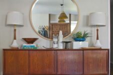 a stained credenza as part of a stylish mid-century modern living room or dining space with matching table lamps